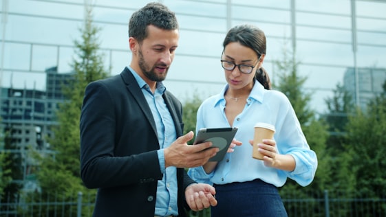 Two professionals reviewing technology strategy on a tablet