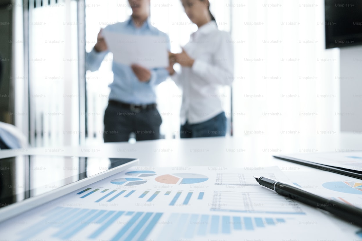 Business professionals reviewing financial charts and data